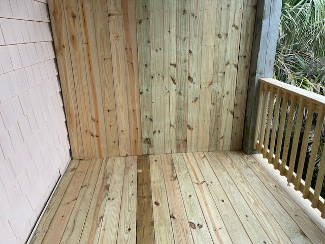 Damaged wooden siding on a house corner, with rot and exposed structural wood. Damaged wooden siding on a house corner, with rot and exposed structural wood.