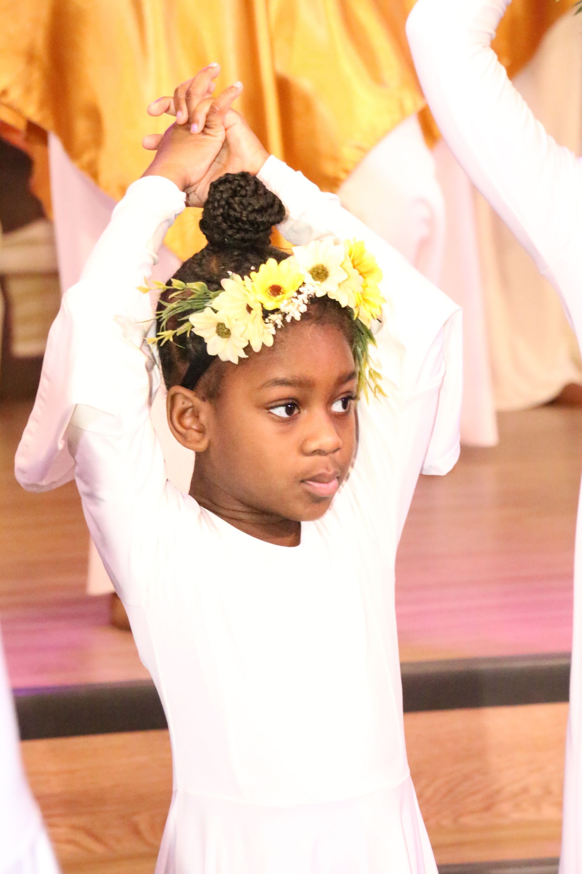 A little girl with a flower crown on her head