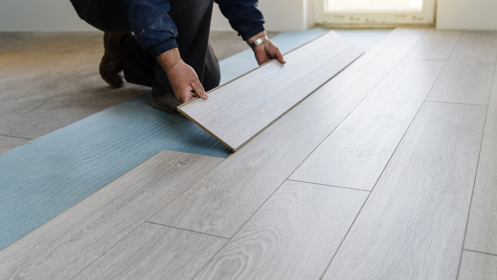 A Person Installing A Laminate Floor