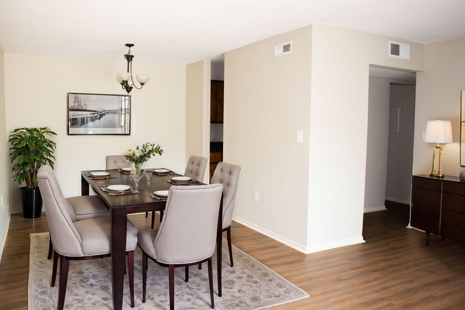 A dining room with a table and chairs in it