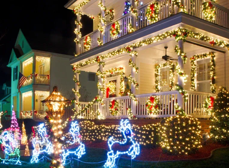 A house is decorated with christmas lights and decorations.