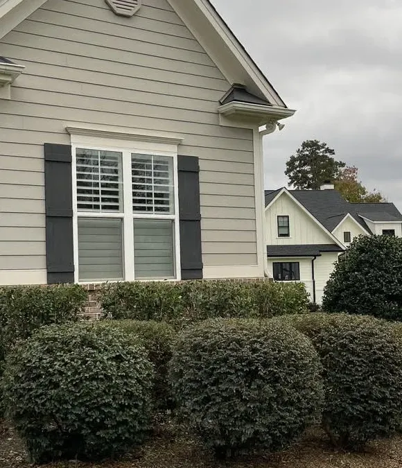 A house with a large window and black shutters