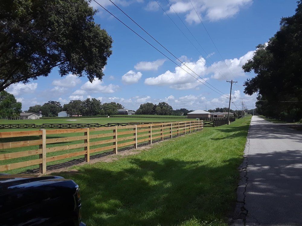 A wooden fence along the side of a road