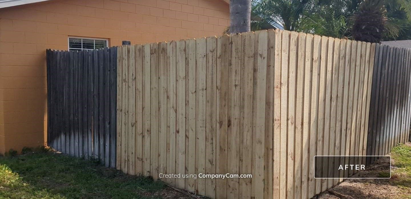 A wooden fence is sitting in front of a house.