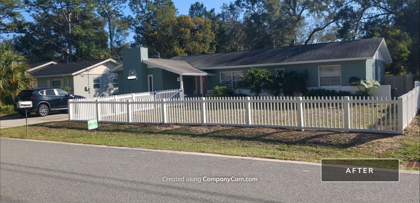 A house with a white picket fence in front of it