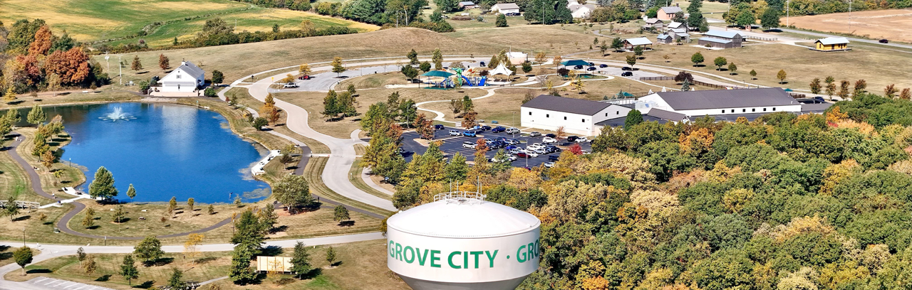 Aerial view of Grove City, with a pond, buildings, and a water tower. Aerial view of Grove City, with a pond, buildings, and a water tower.