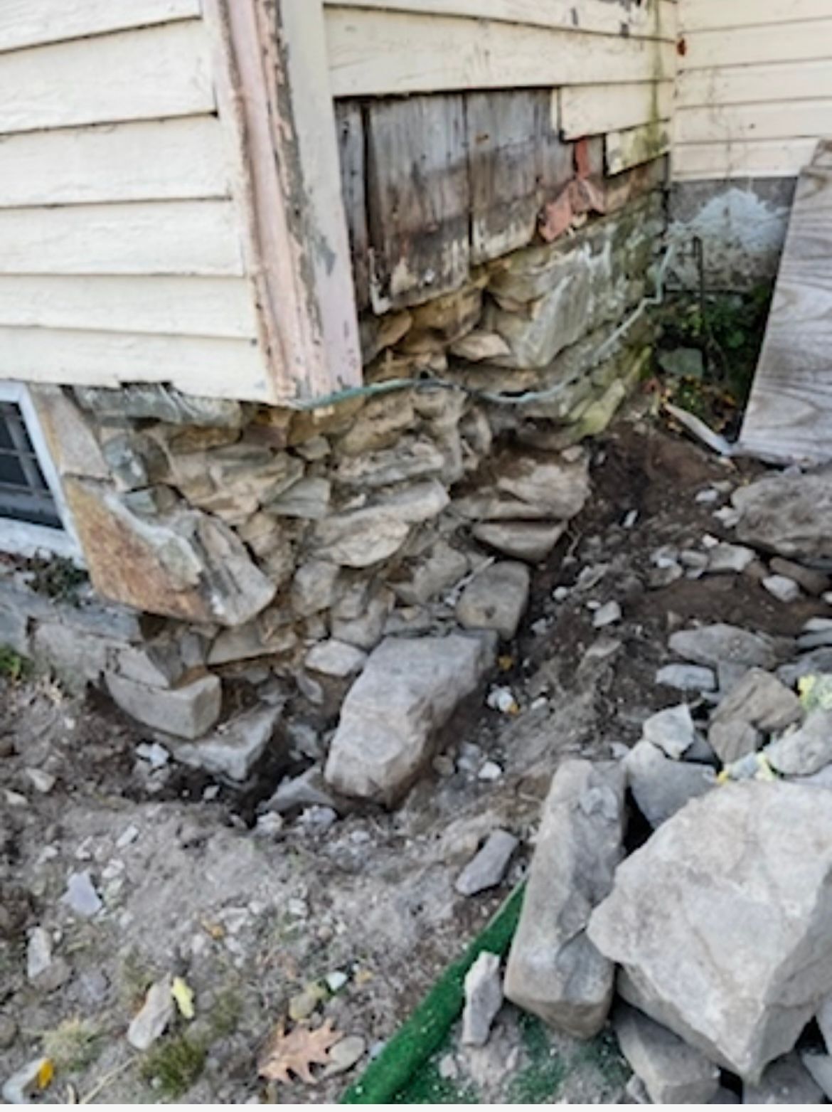A house with a lot of rocks in front of it