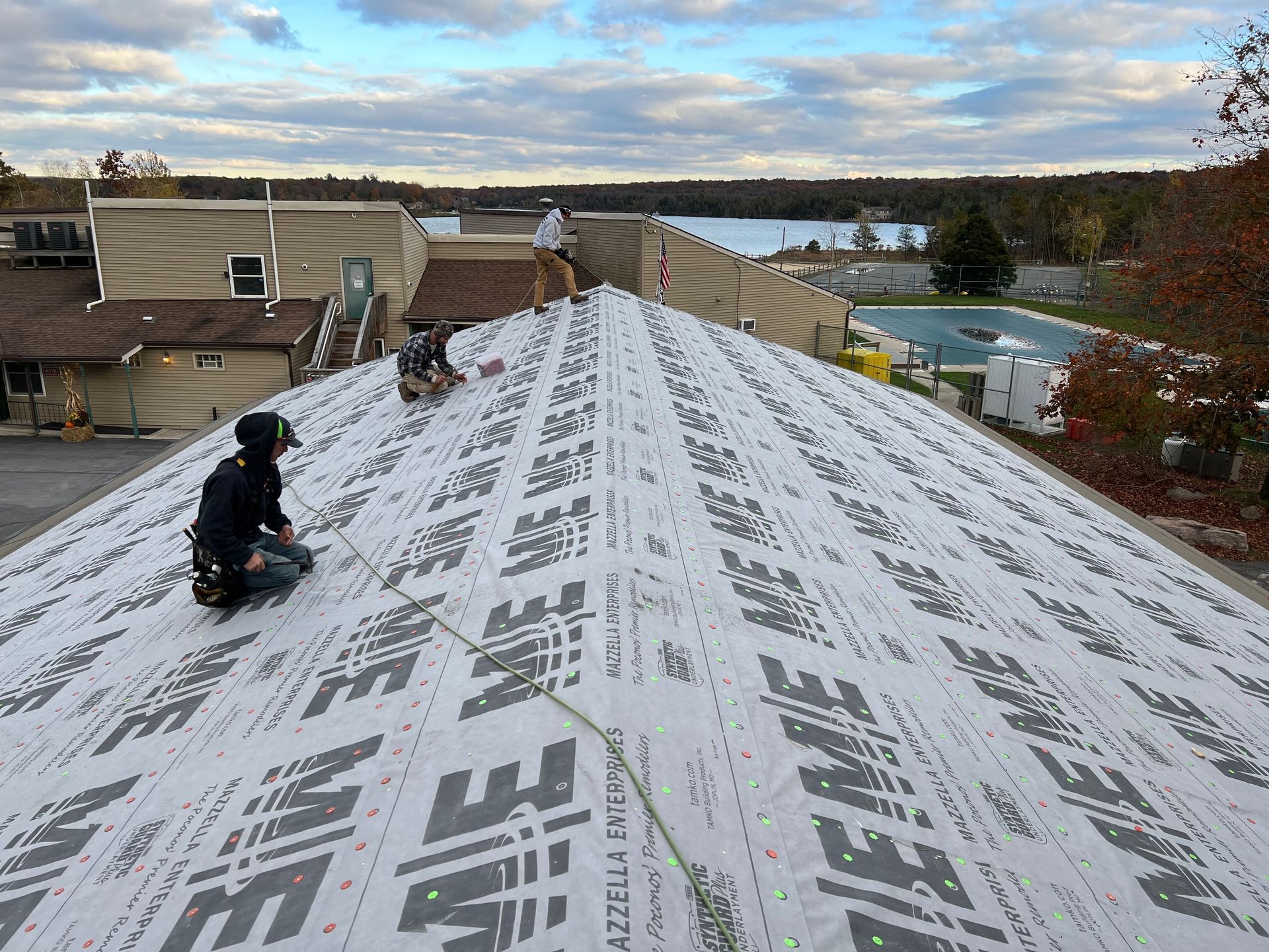 A man is working on the roof of a house.