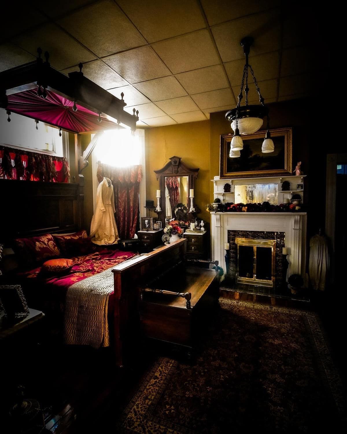 A living room with a fireplace and a bed