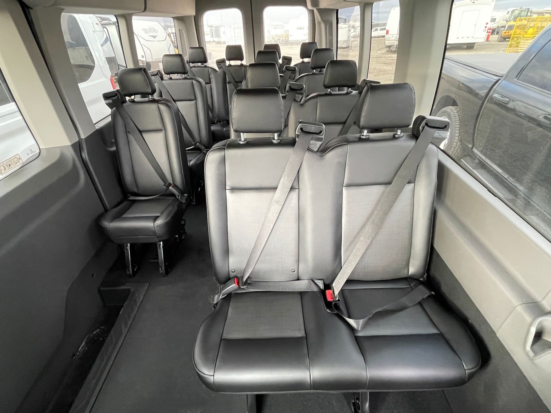 the inside of a van with a lot of seats and seat belts .