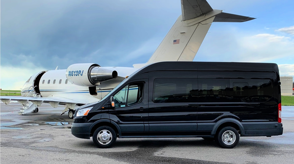 black 14 passenger Ford Transit shuttle bus