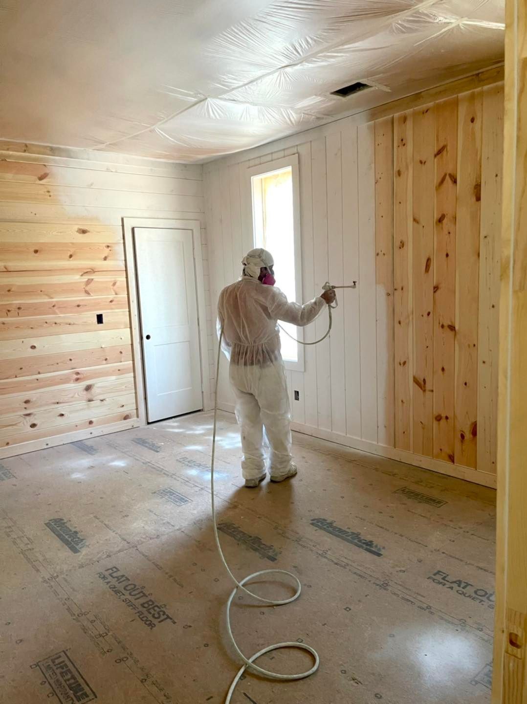 A brick house with a garage and driveway is lit up at night.