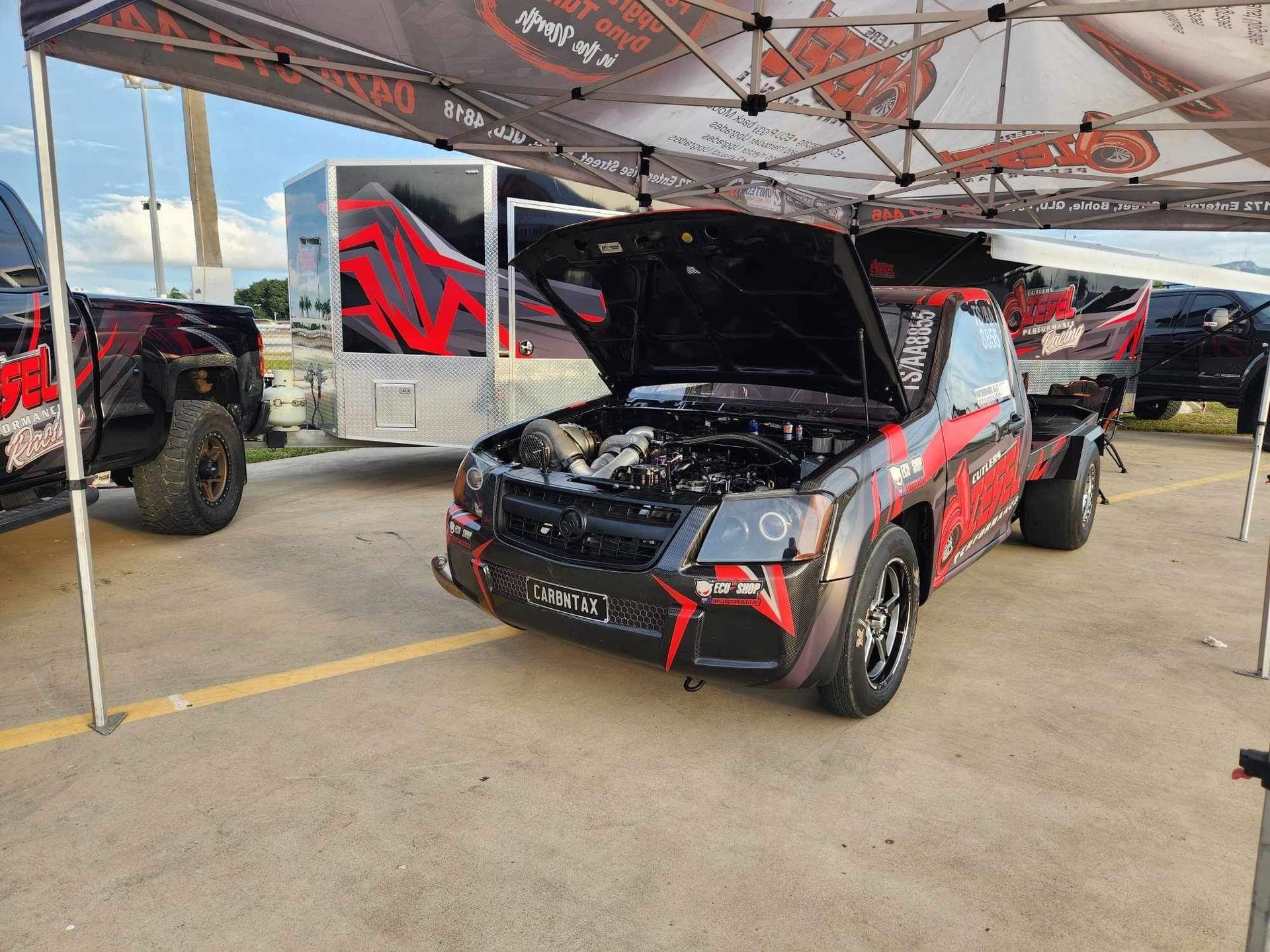 Black and red truck with the hood up has a license plate - Mount Saint John, QLD - Cutlers Diesel Performance