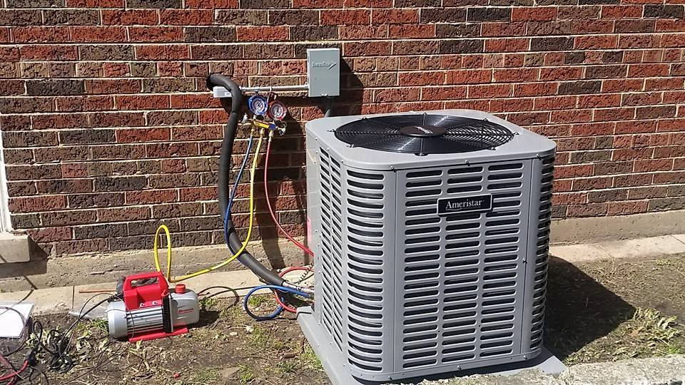 An air conditioner is being installed on the side of a brick commercial building in Chicago.