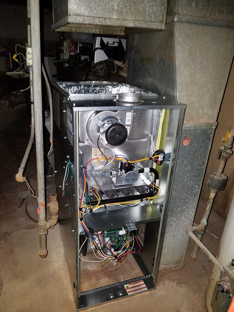 The inside of an air conditioner is shown in a basement.