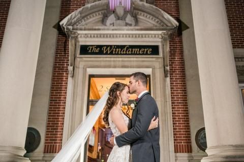 Bride and groom embrace in front of 