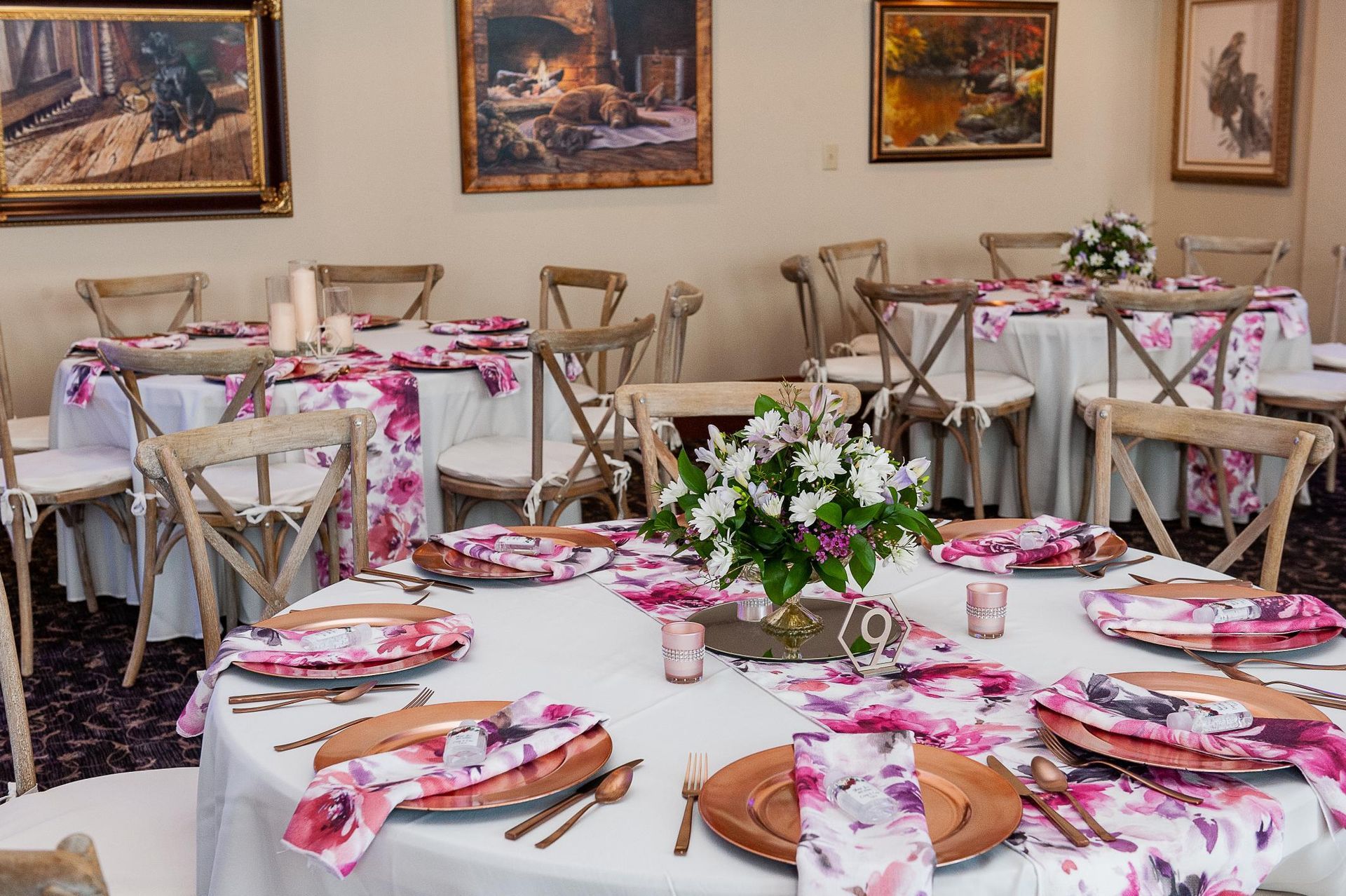 Elegant event tables with pink floral accents and decor.