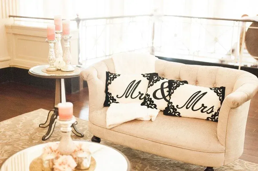 A cream-colored loveseat with 