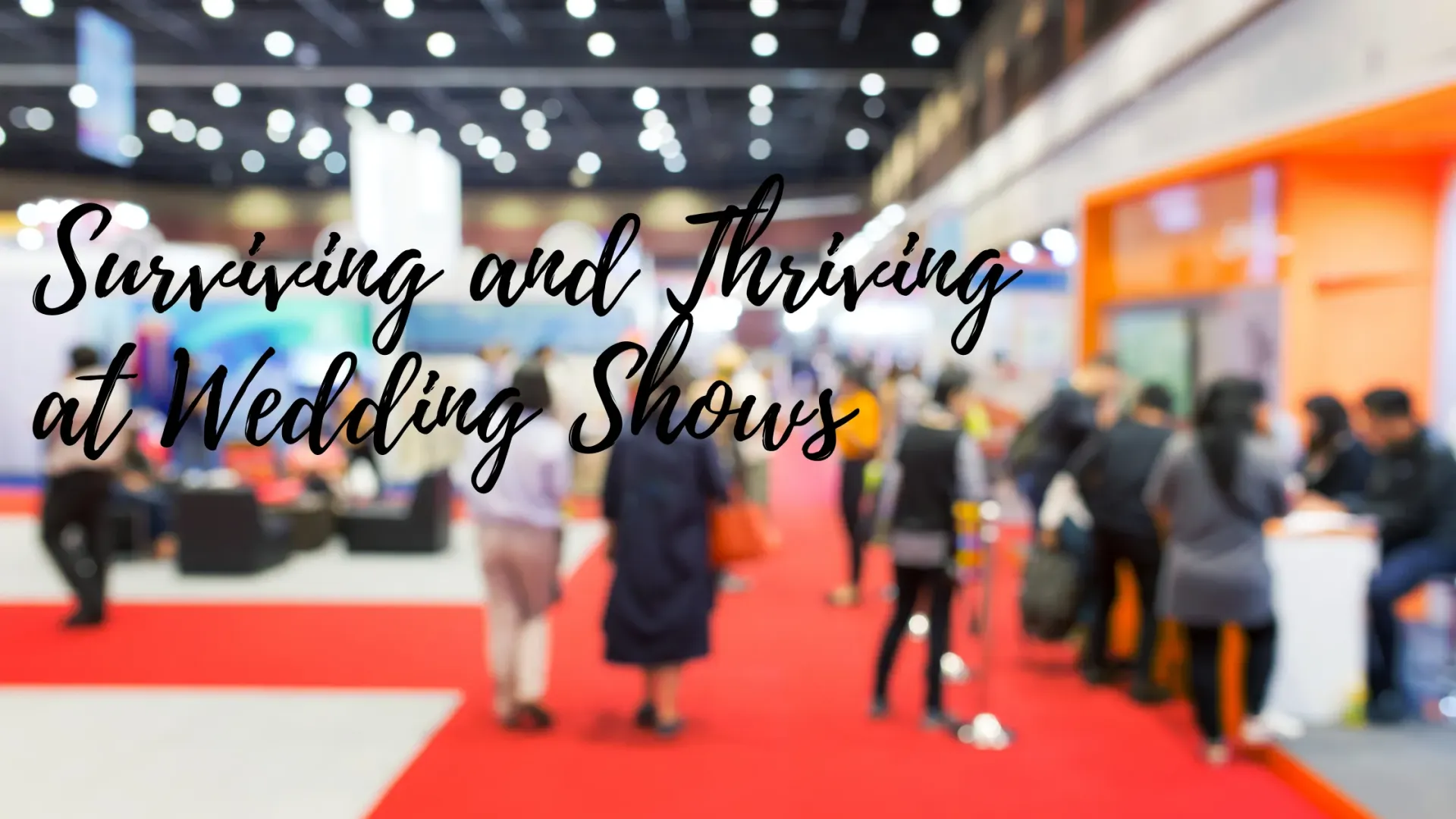 Blurred image of a wedding show with vendors and attendees. Red carpet, orange and white accents,