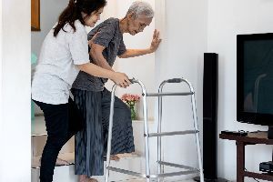 Woman Holding Old Woman - All Tapz International LLC