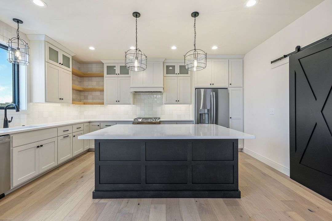 There is a large island in the middle of the kitchen.