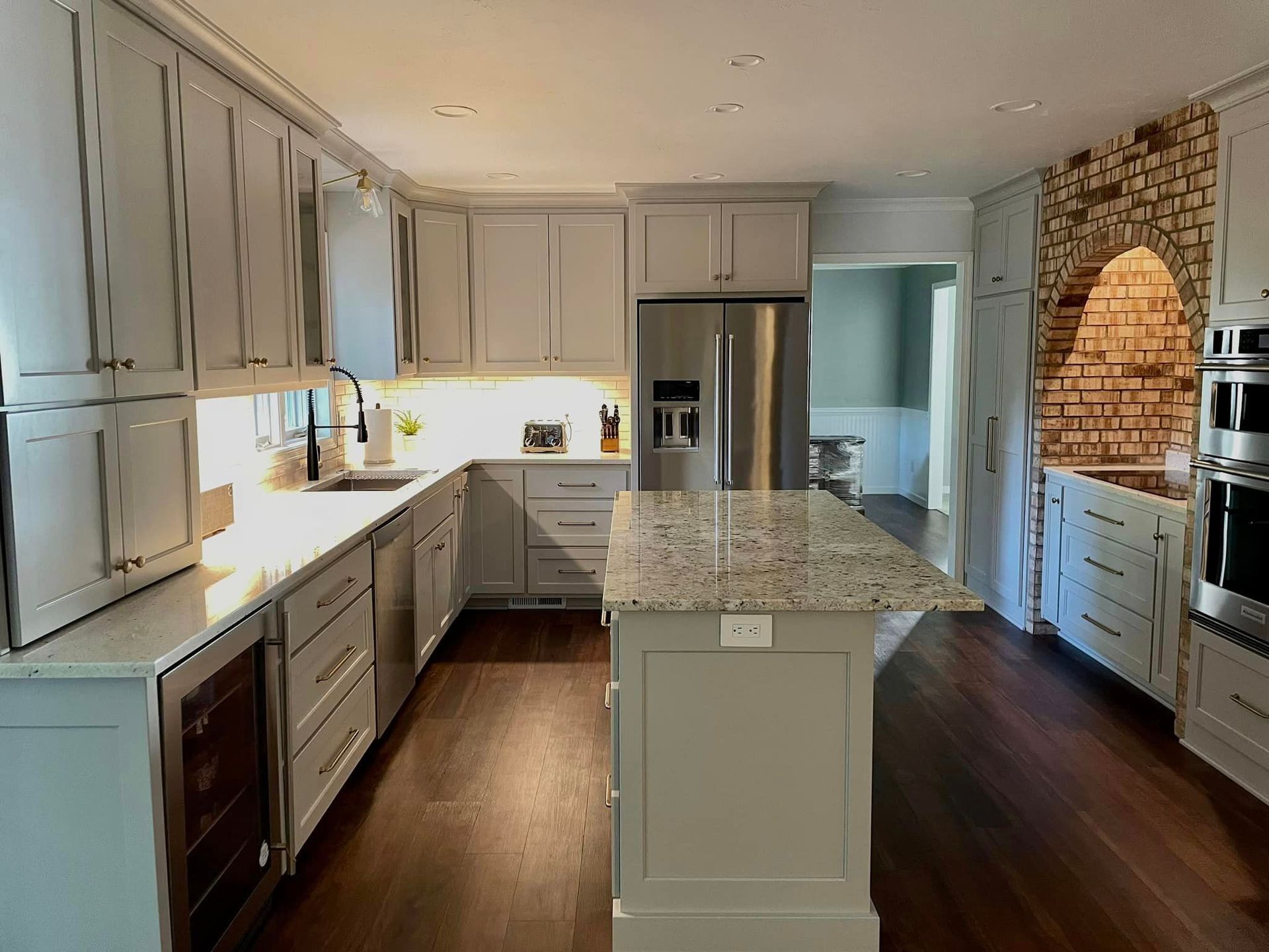 A kitchen with stainless steel appliances and granite counter tops.