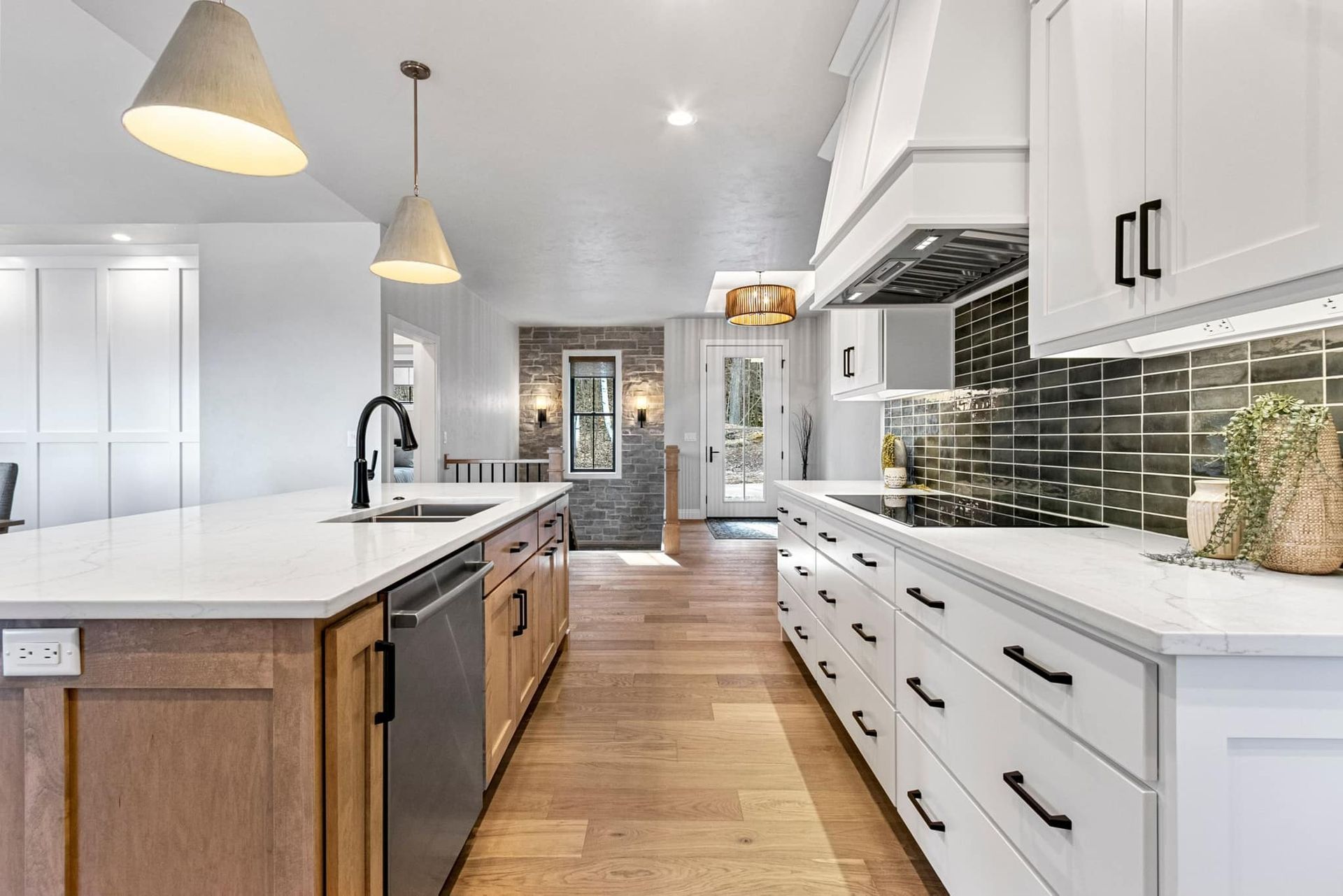 A kitchen with white cabinets , wooden cabinets , stainless steel appliances , and a large island.