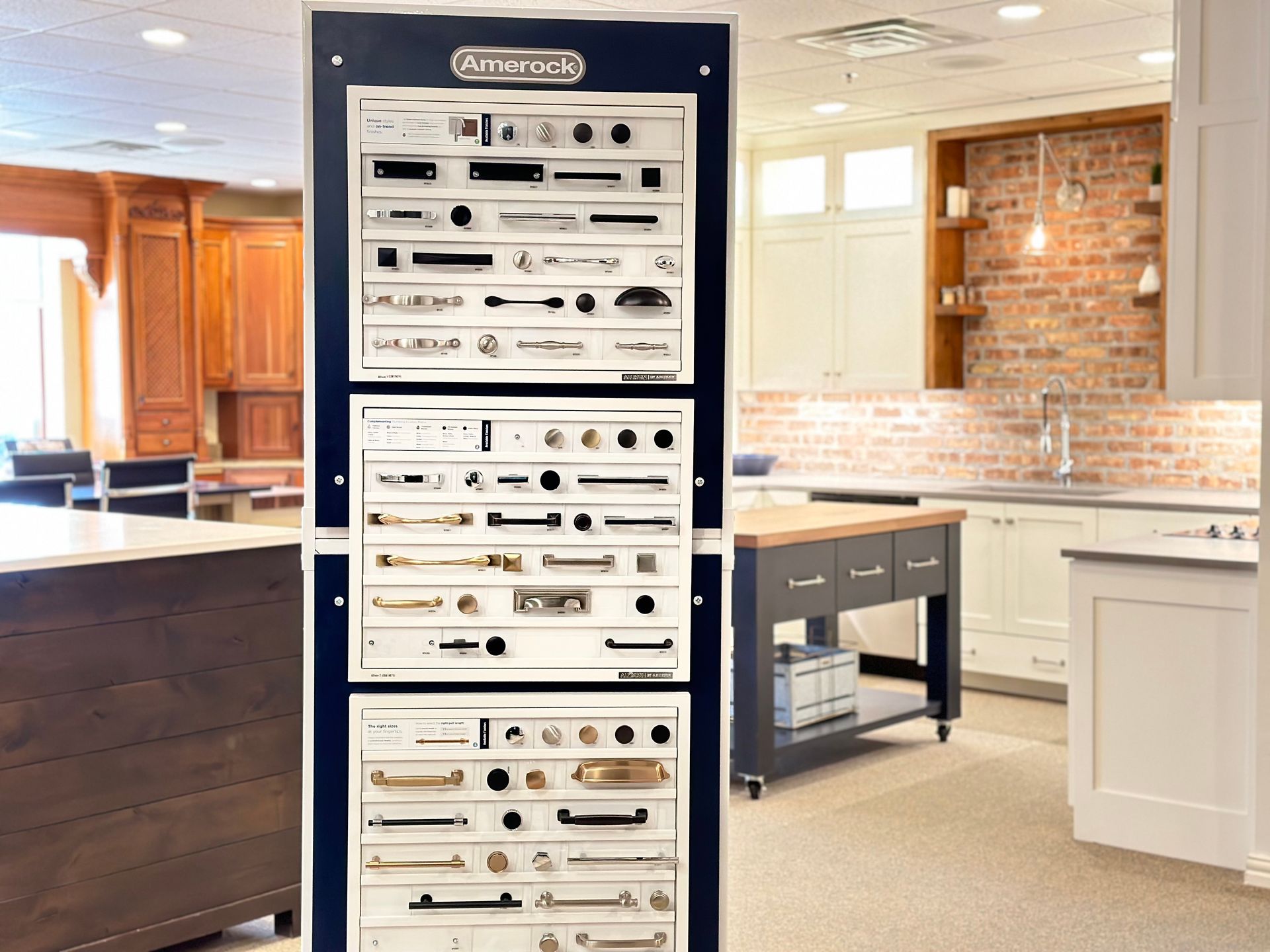 A display of cabinet handles in a kitchen in a showroom.