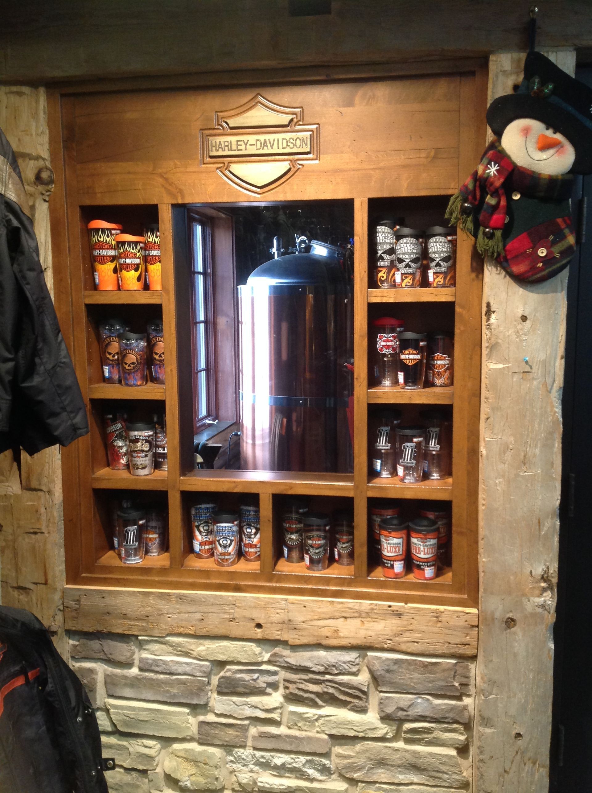 A harley davidson logo is on a wooden wall