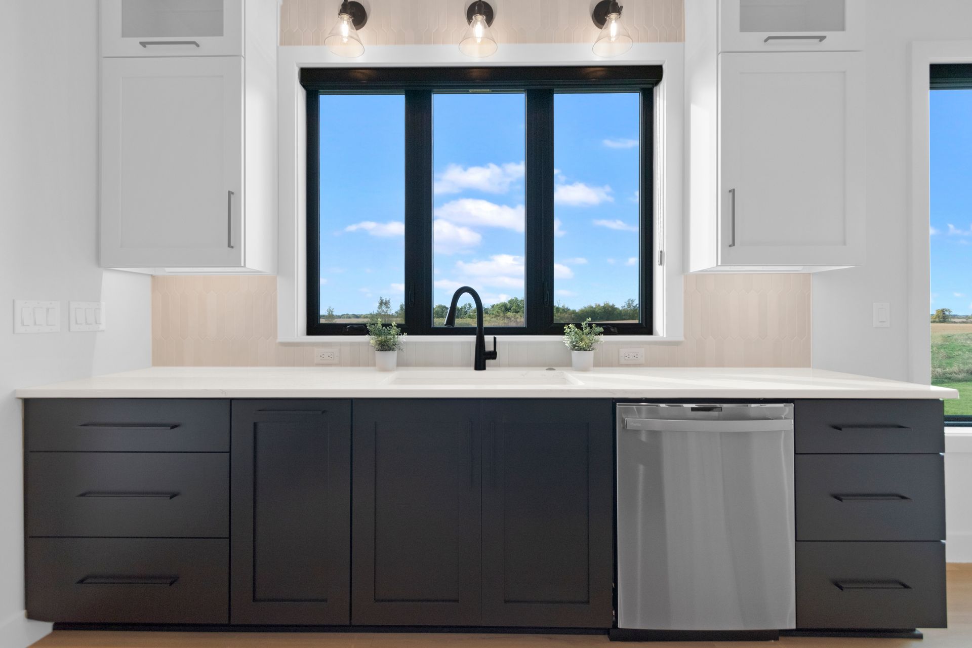 A kitchen with a large island and white cabinets