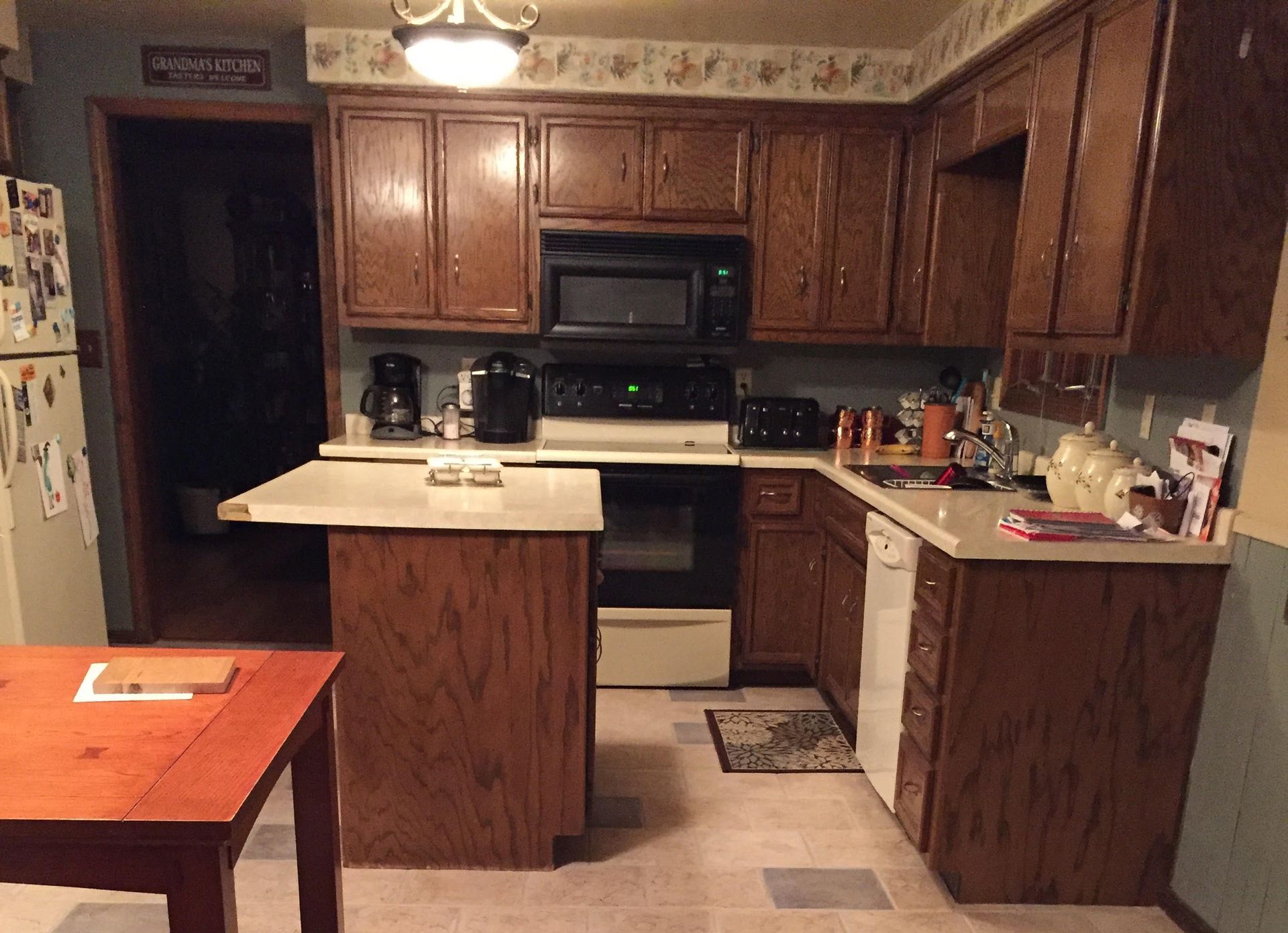 A kitchen with wooden cabinets and white appliances