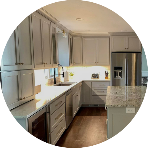 A kitchen with gray cabinets and granite counter tops