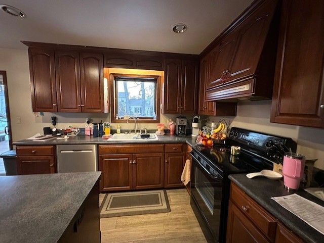 A kitchen with wooden cabinets and a black stove top oven