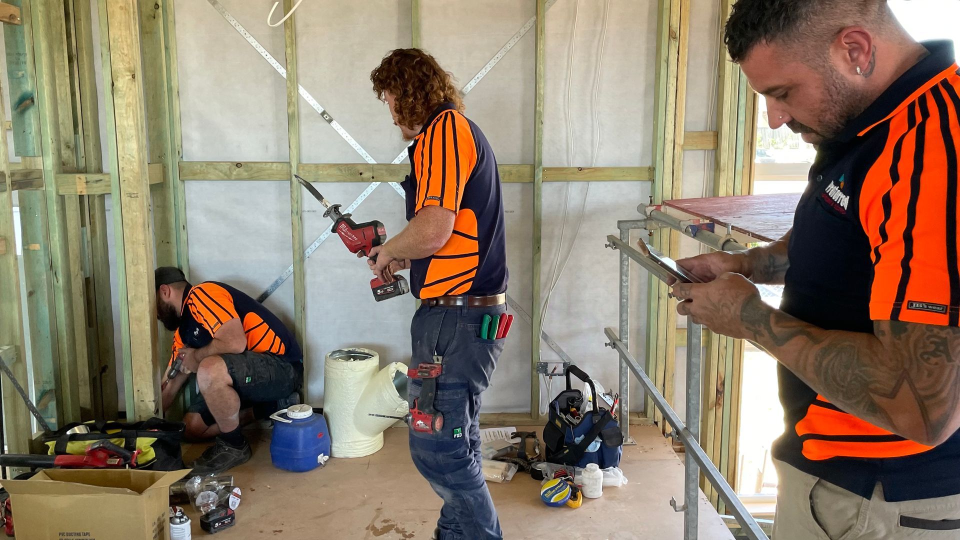 A group of construction workers are working on a building.