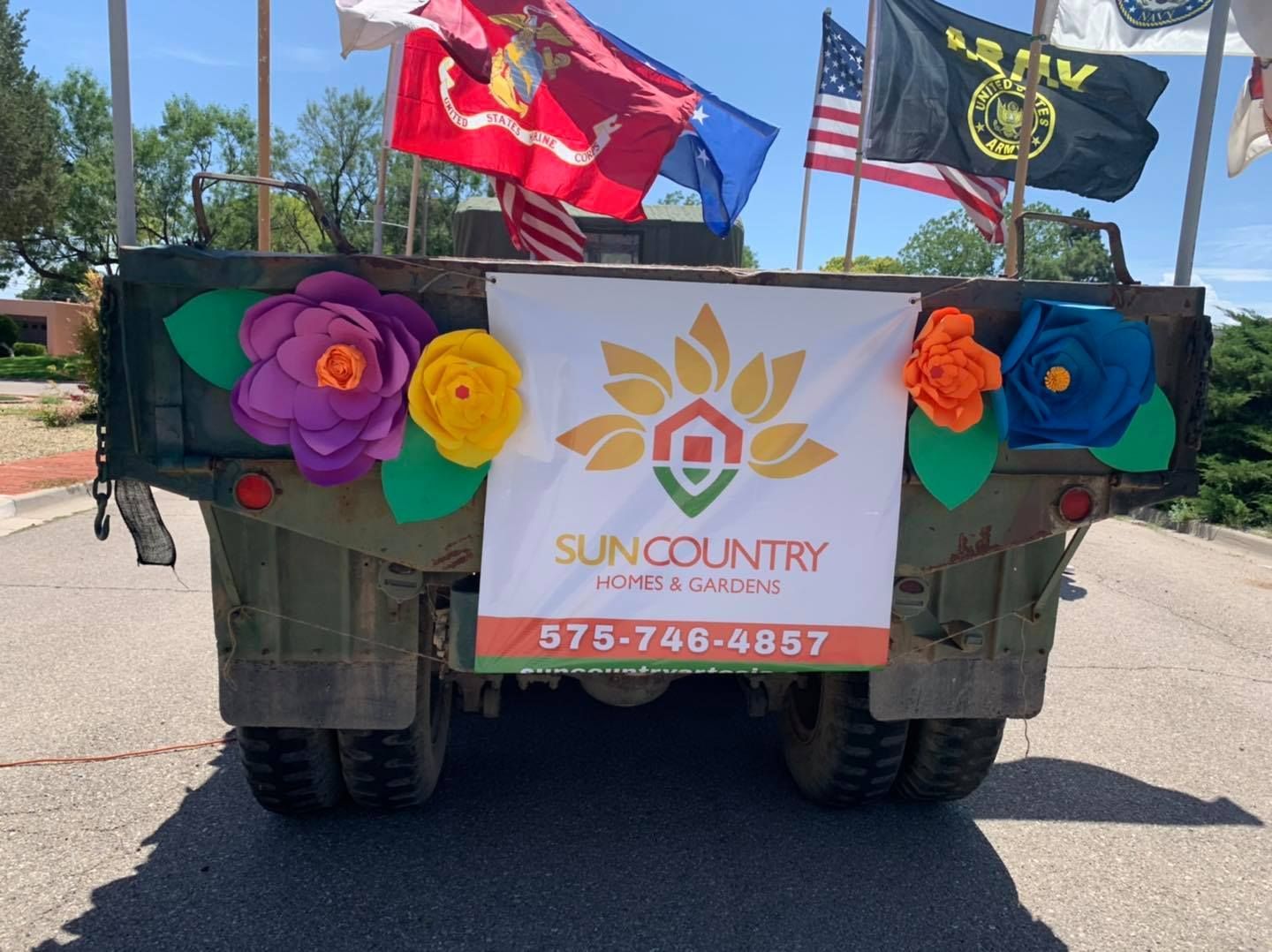 A sign on the back of a military vehicle says sun country