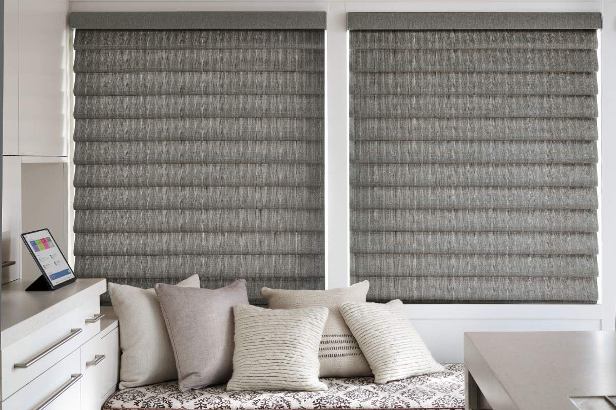 Hunter Douglas Vignette® Modern Roman Shades hanging on a home’s windows.