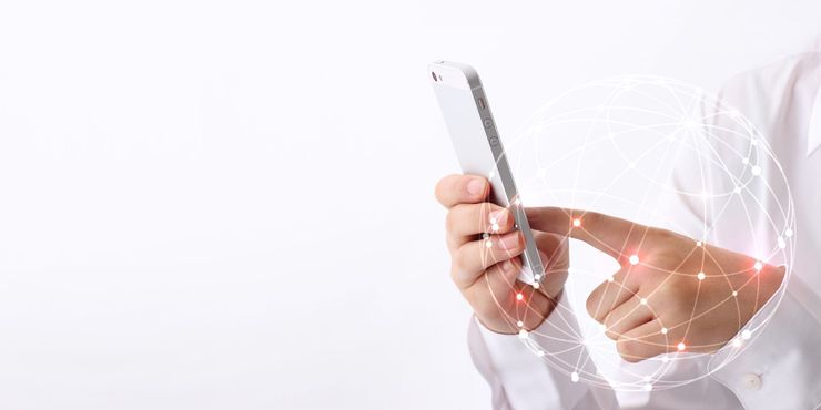 Person holding a smartphone, touching the screen, with a digital network graphic overlay.