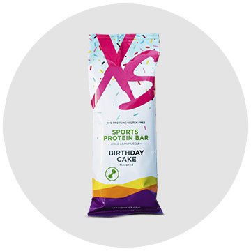 A sports protein bar with a birthday cake flavor on a white background.