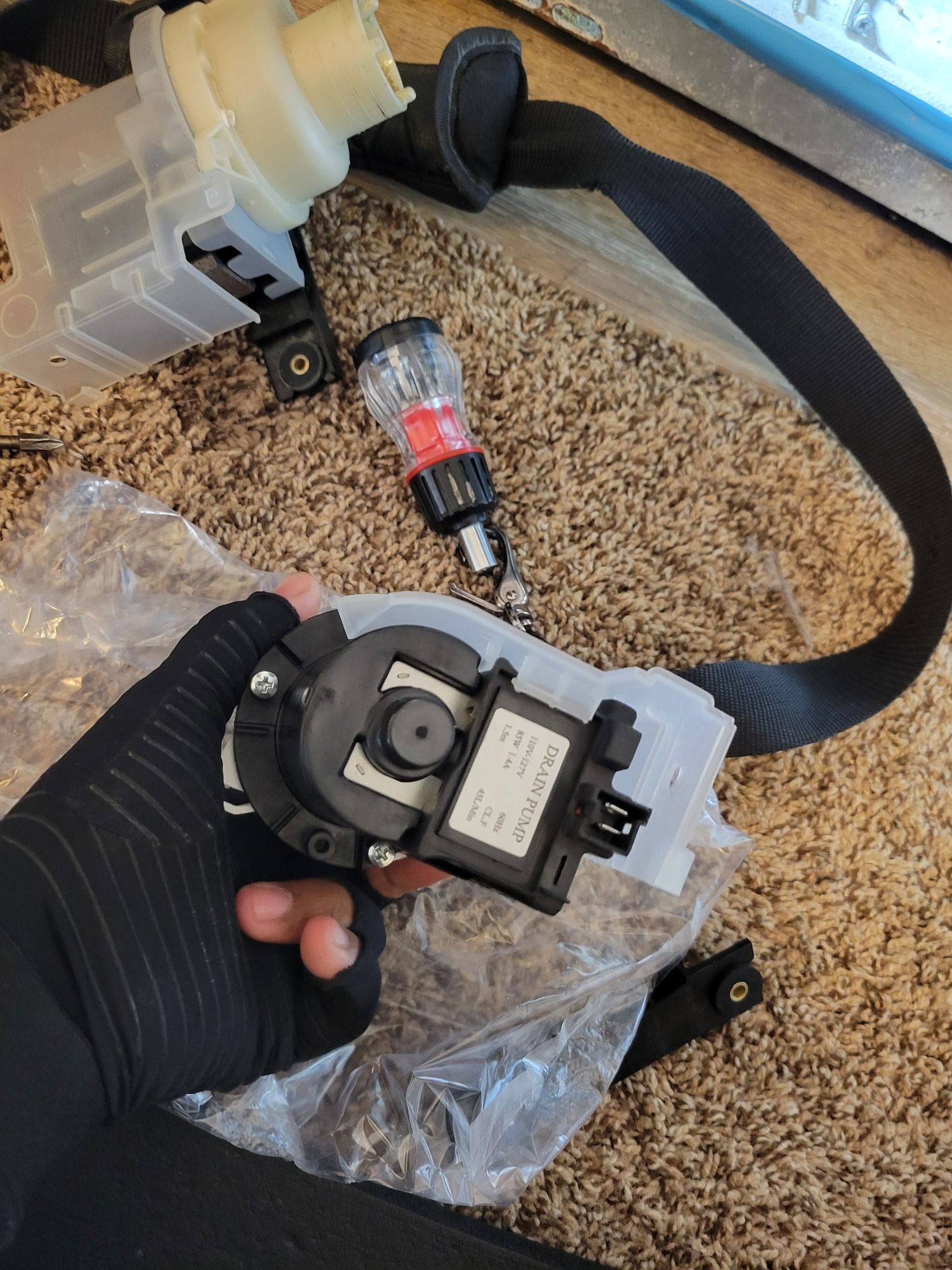 A person is holding a piece of equipment in their hand.