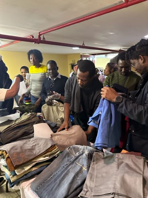 A group of people are looking at clothes in a store
