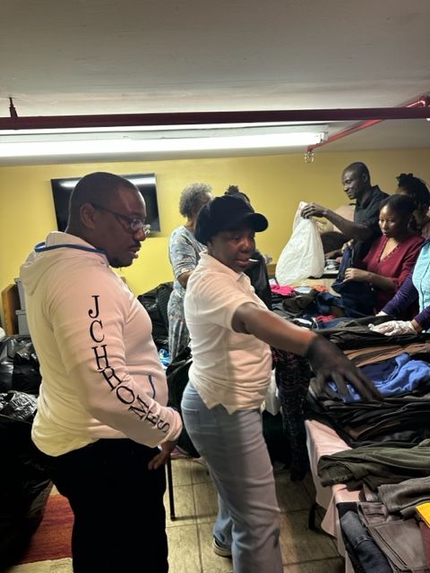 A man wearing a jcpenney shirt is standing next to a woman