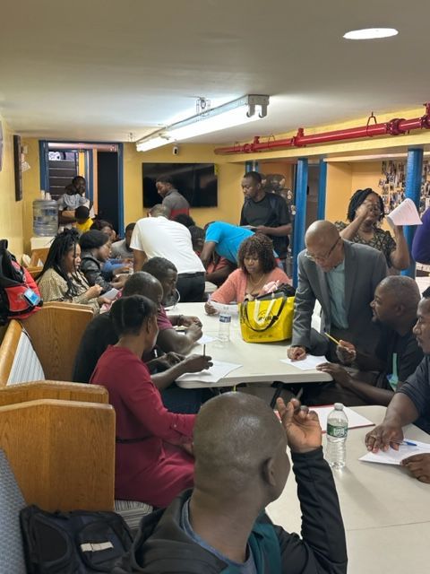 A group of people are sitting around a table in a restaurant
