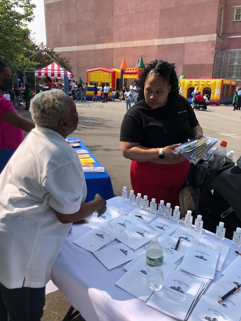 Two women at a table with brochures.