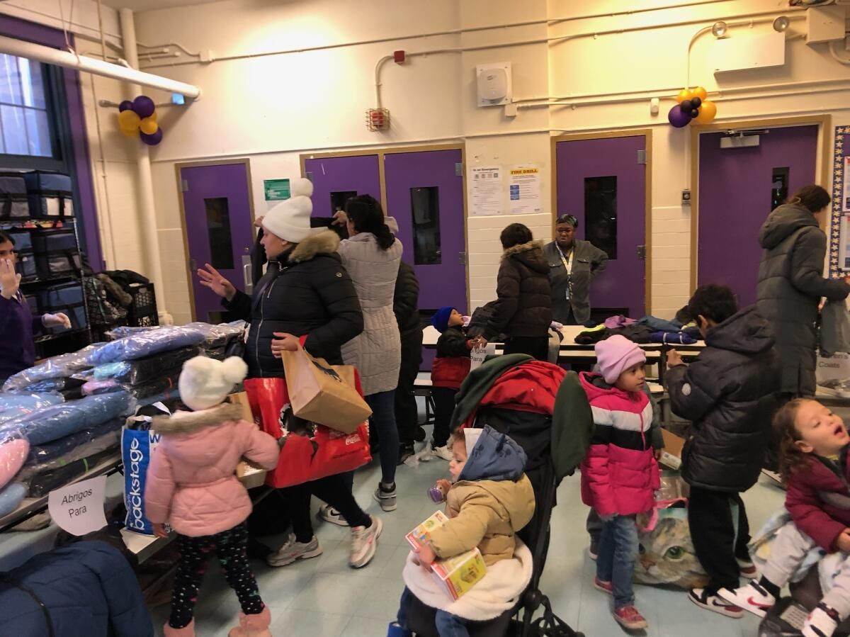 A group of people are standing in a room with purple doors.