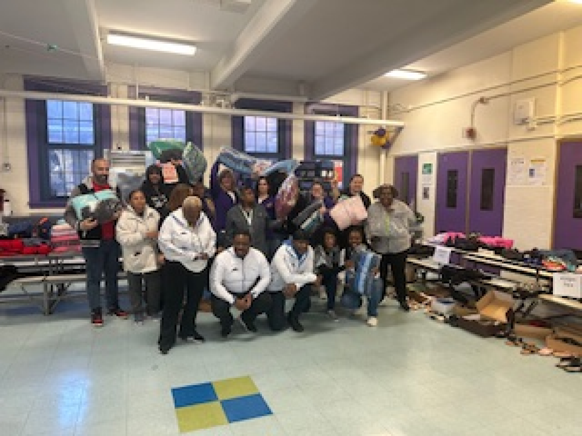 A group of people are posing for a picture in a room.