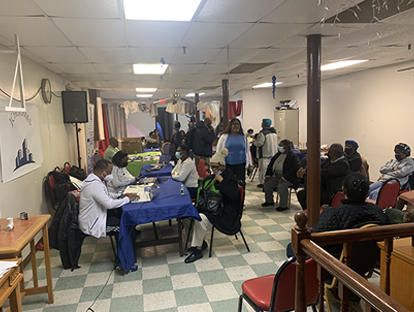 A group of people are sitting at tables in a room.