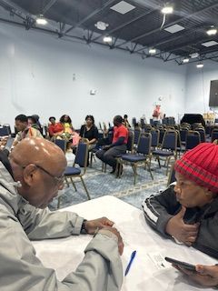 A group of people are sitting at tables in a room.