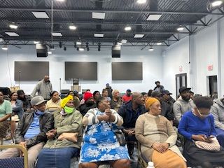 A large group of people are sitting in a room.