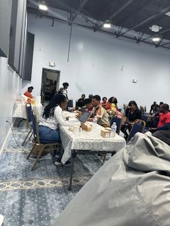 A group of people are sitting at tables in a room.