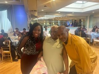 A group of people are posing for a picture in a room.